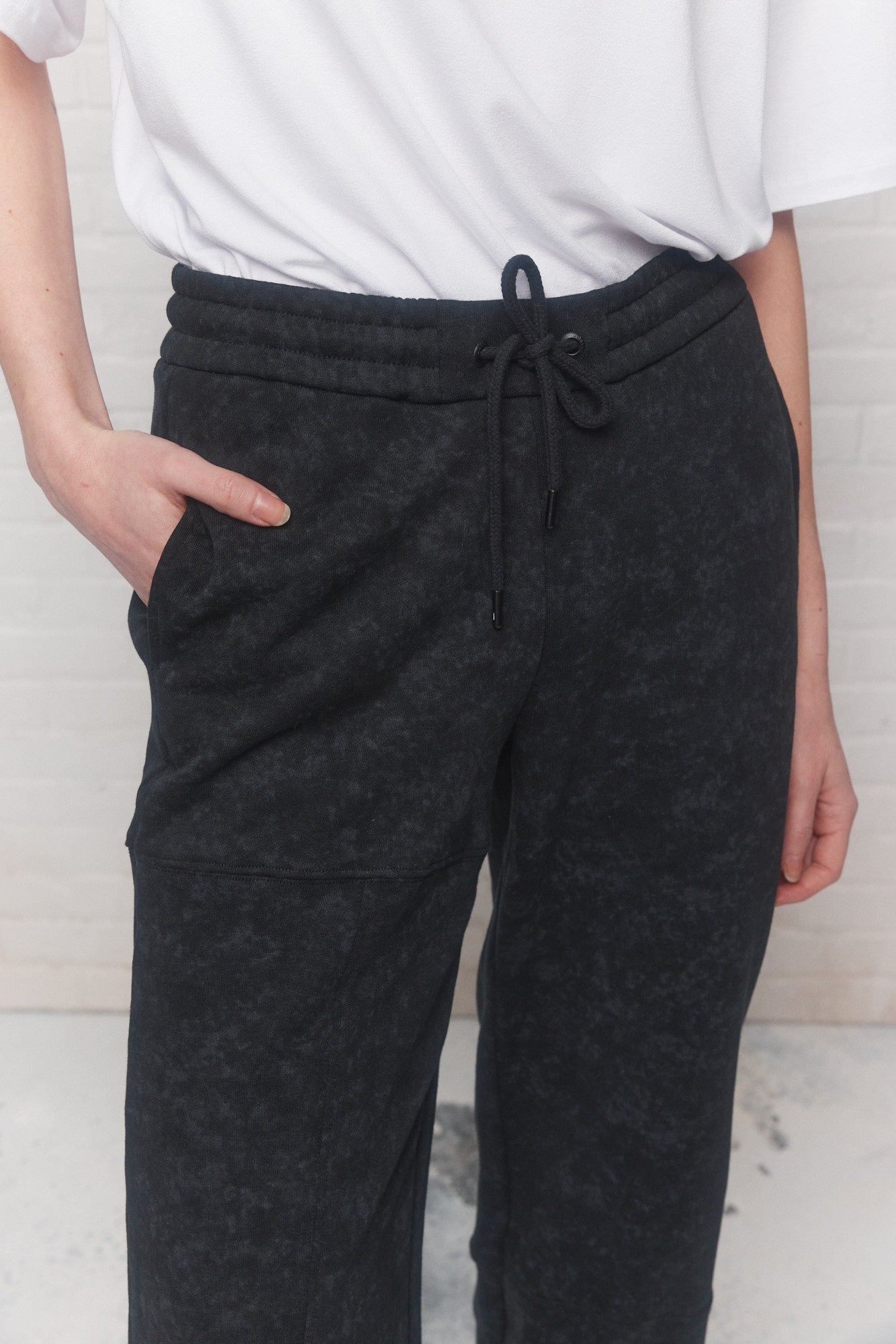Black faded effect pants with asymmetrical cutouts | Dualey