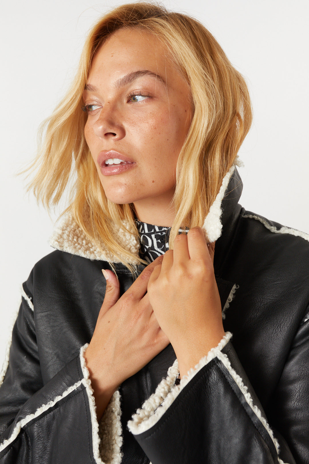 Black faux leather and sheepskin effect coat | Rebecca